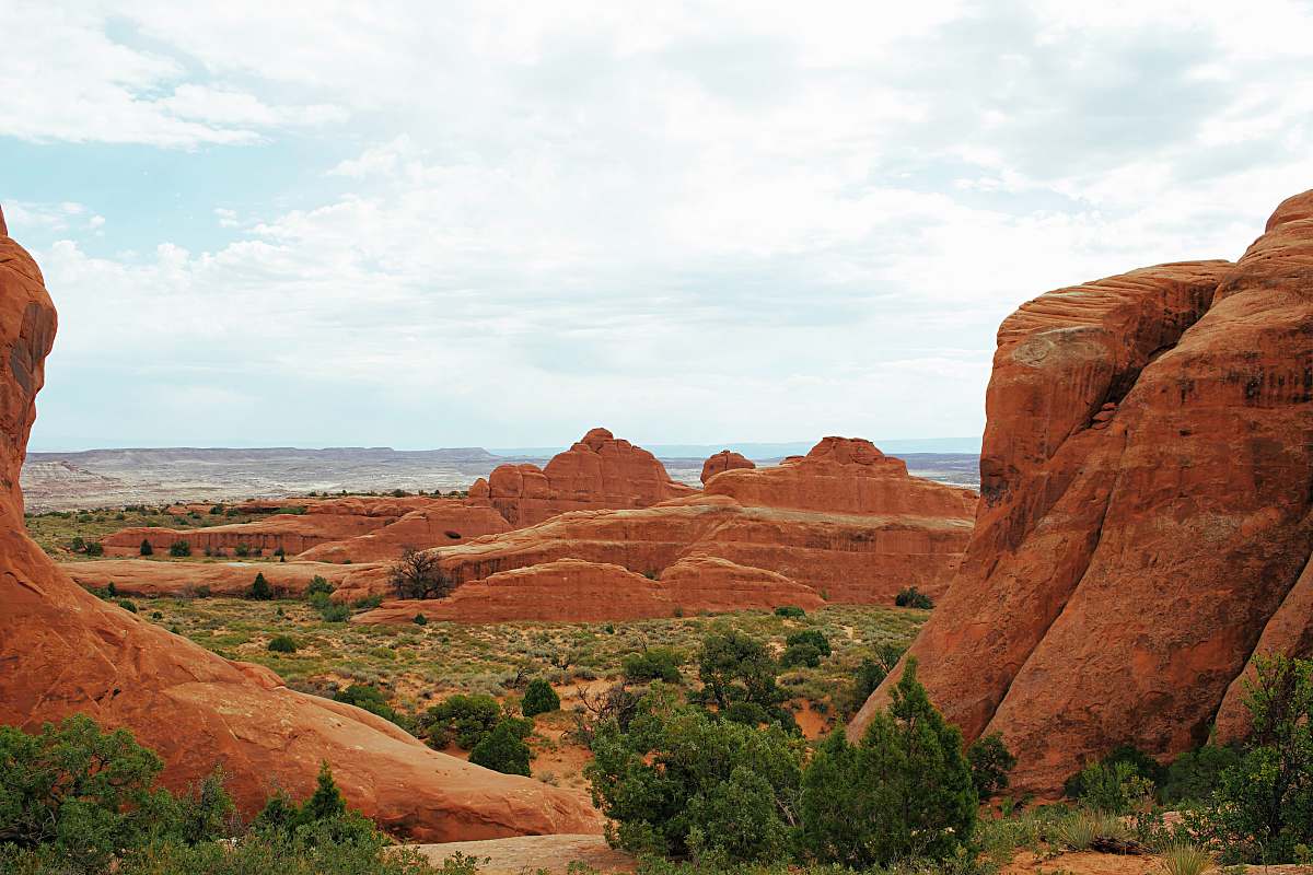 arches national park brown rock formation near green trees during daytime usa